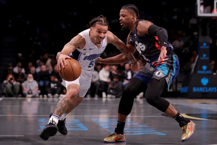 Orlando Magic guard Cole Anthony defended by Brooklyn Nets guard Dennis Smith Jr.